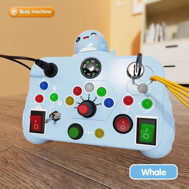 Toy control panel with colorful buttons and a whale design on a wooden surface