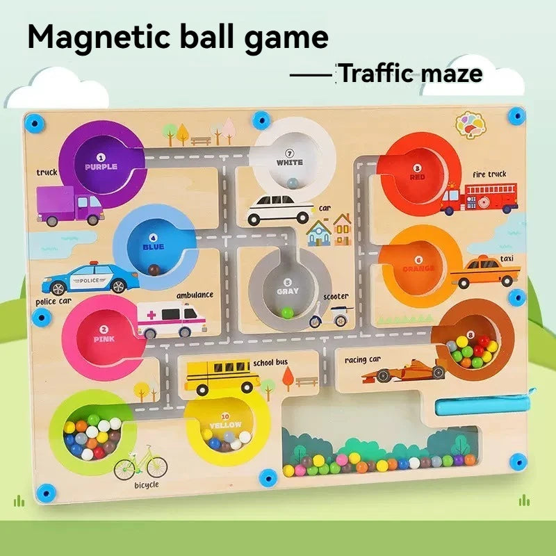 Wooden traffic maze game with colorful magnetic balls and vehicles on a light blue background.