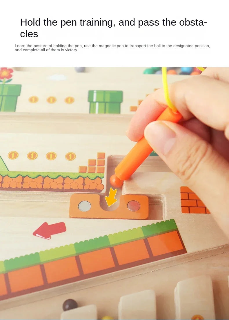 Hand holding a magnetic pen over a educational toy with obstacles