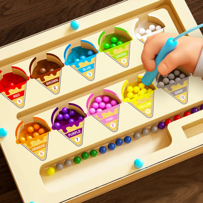 Color sorting game with colorful bins and beads on a wooden board.